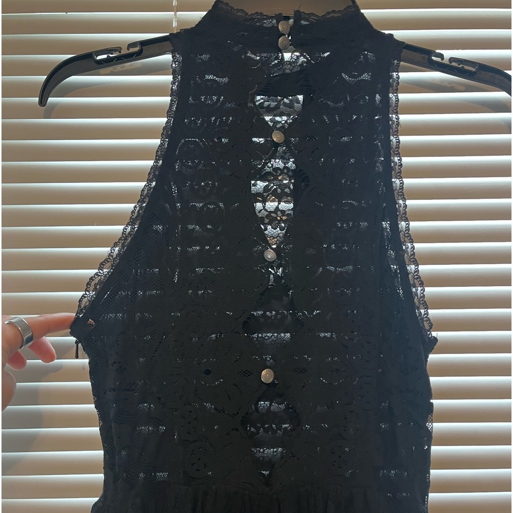 Black lace free people mini dress with button detailing on the back.